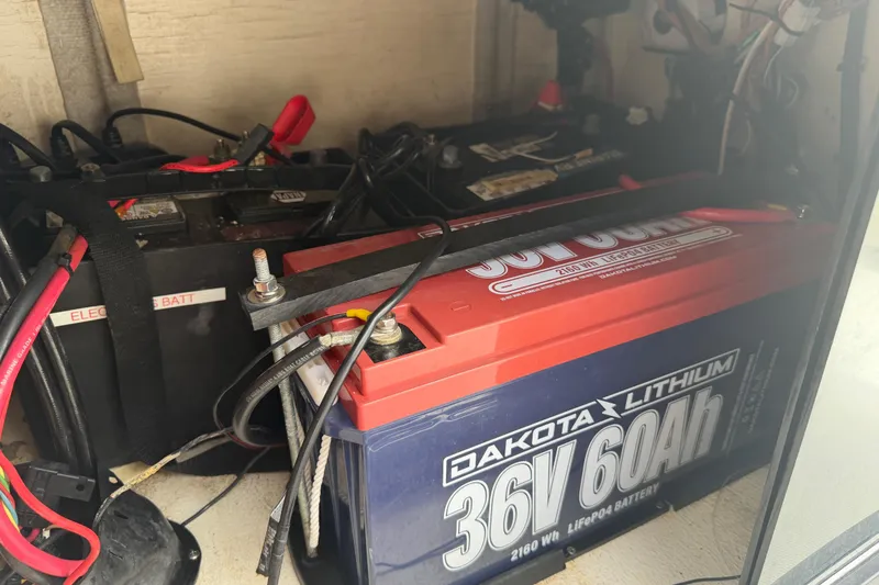 Slide: The Image of Battery compartment of a 1997 Regulator 26 Center Console with Dakota Lithium battery. - 17