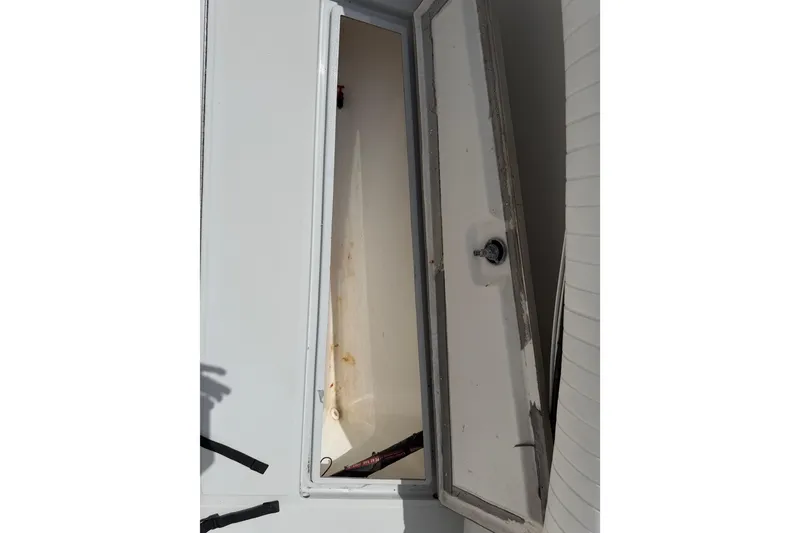 Slide: The Image of Open storage compartment on a 1997 Regulator 26 Center Console boat. - 18