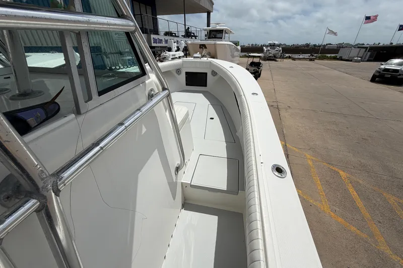 Slide: The Image of 1997 Regulator 26 Center Console boat docked, showcasing spacious deck and sleek design. - 21