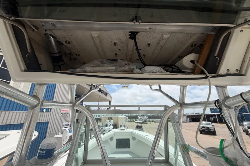 Slide: The Image of 1997 Regulator 26 Center Console boat interior with open storage compartment. - 22