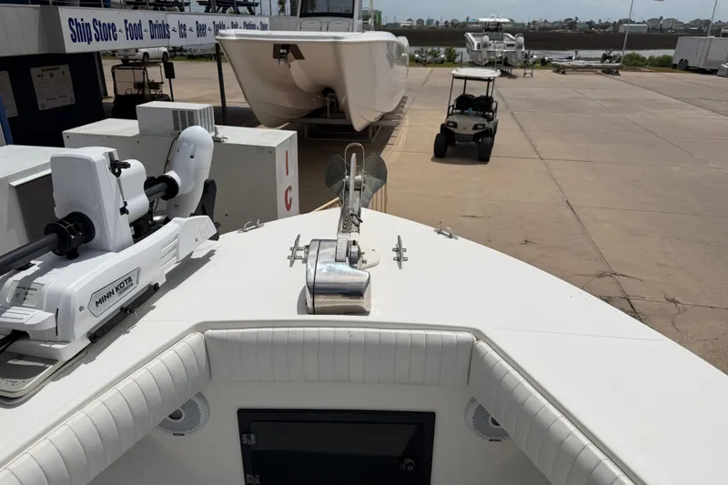 Slide: The Image of 1997 Regulator 26 Center Console boat with Minn Kota motor at marina. - 24