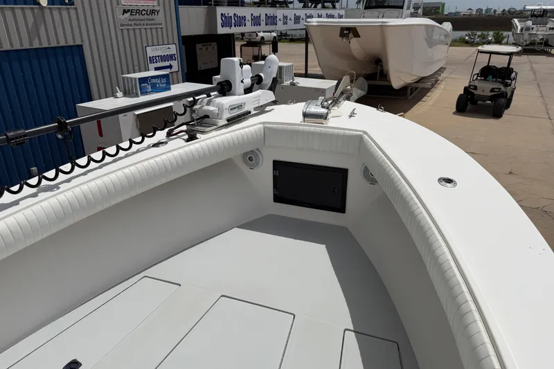 Slide: The Image of 1997 Regulator 26 Center Console boat at a marina with equipment and signage. - 25