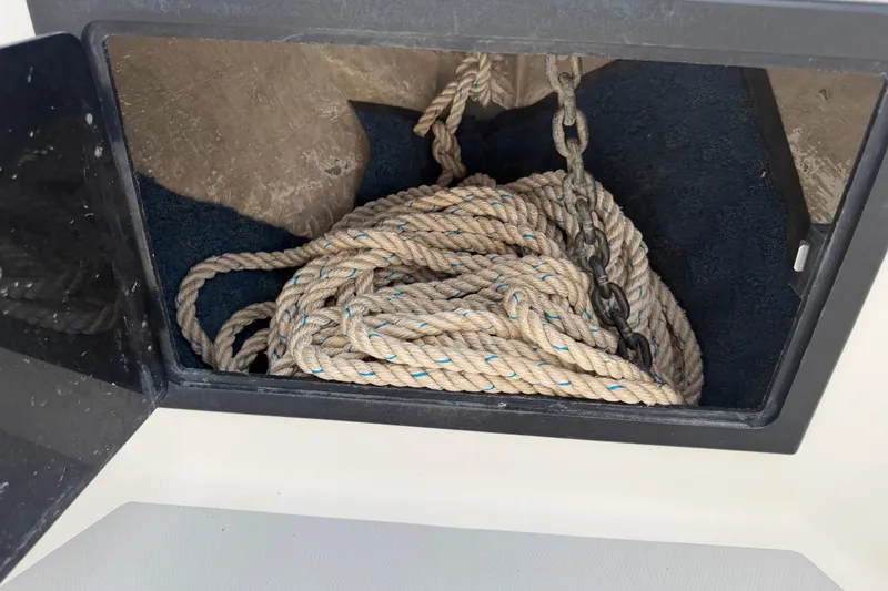 Slide: The Image of Anchor storage compartment with rope and chain on a 1997 Regulator 26 Center Console boat. - 29