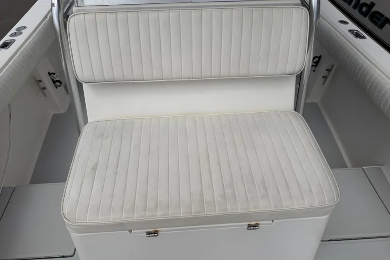 Slide: The Image of White cushioned seating on a 1997 Regulator 26 Center Console boat. - 31