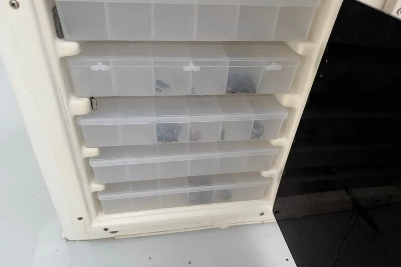 Slide: The Image of Tackle storage compartments on a 1997 Regulator 26 Center Console boat. - 34