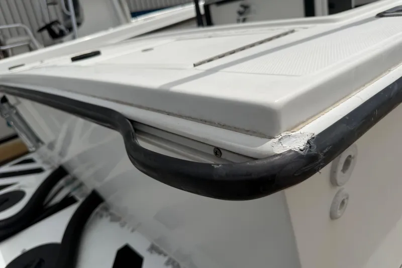 Slide: The Image of Close-up of a 1997 Regulator 26 Center Console boat's edge with visible wear. - 35