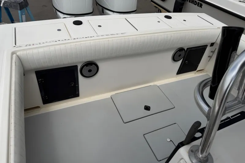 Slide: The Image of 1997 Regulator 26 Center Console boat interior with storage compartments and speakers. - 36