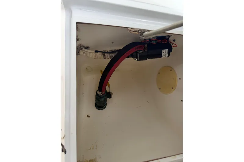 Slide: The Image of Interior view of a 1997 Regulator 26 Center Console boat compartment with wiring and hoses. - 37