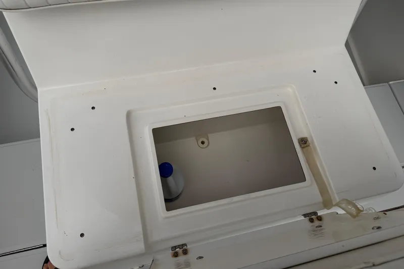 Slide: The Image of Open storage compartment on a 1997 Regulator 26 Center Console boat. - 38