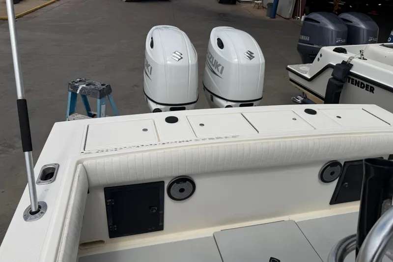 Slide: The Image of 1997 Regulator 26 Center Console boat with Suzuki outboard engines in a marina setting. - 40