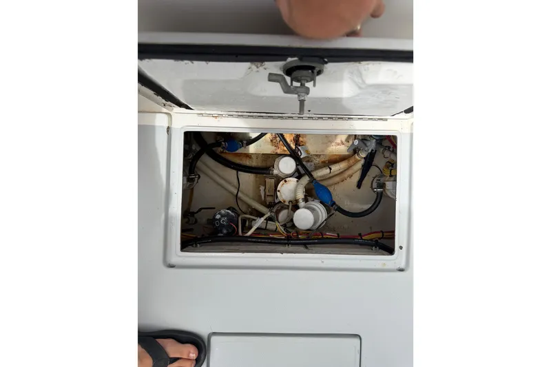 Slide: The Image of Open hatch of a 1997 Regulator 26 Center Console boat showing internal components. - 41