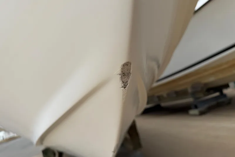 Slide: The Image of Close-up of damage on a 1997 Regulator 26 Center Console boat hull. - 47