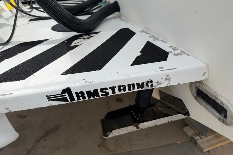 Slide: The Image of 1997 Regulator 26 Center Console boat with Armstrong bracket, showing wear and black stripes. - 48