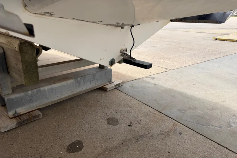 Slide: The Image of 1997 Regulator 26 Center Console boat on a stand, showing hull and transducer. - 50