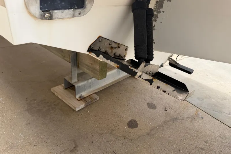 Slide: The Image of 1997 Regulator 26 Center Console boat on blocks, showing hull and trim tabs. - 51