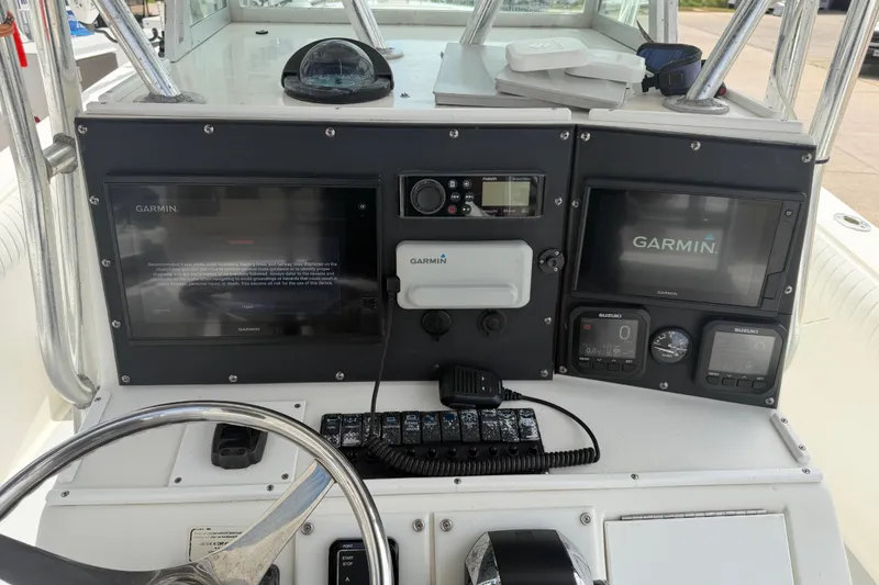 Slide: The Image of 1997 Regulator 26 Center Console dashboard with Garmin navigation displays and controls. - 8