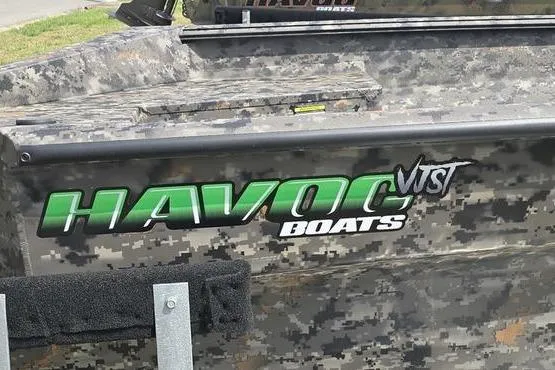 Slide: The Image of Camouflage-patterned Havoc 1553 VJST boat, 2026 model, with bold green logo. - 4