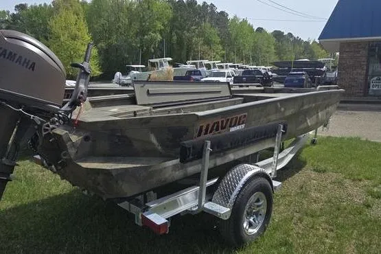 Slide: The Image of 2026 Havoc 1860 DBST boat on trailer, parked outdoors near dealership. - 12