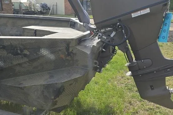 Slide: The Image of 2026 Havoc 1860 DBST boat with outboard motor on grassy area. - 7