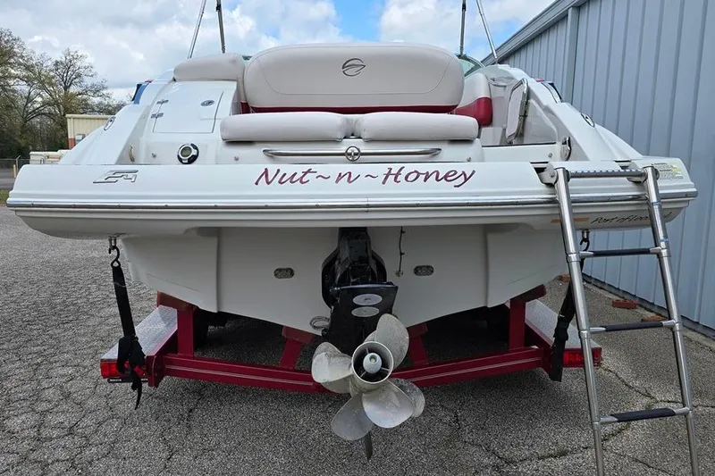 Slide: The Image of 2012 Crownline Eclipse E4 boat named "Nut-n-Honey" on a trailer with ladder. - 15