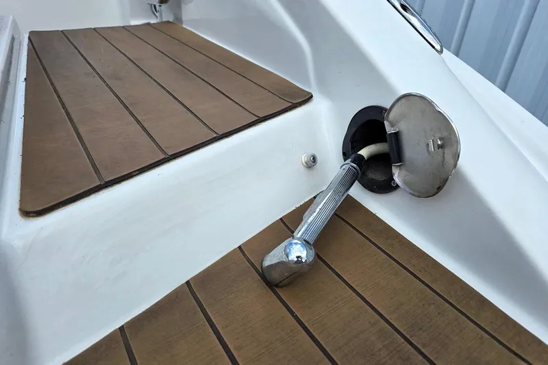 Slide: The Image of 2012 Crownline Eclipse E4 boat deck with fuel filler cap and wooden flooring. - 24