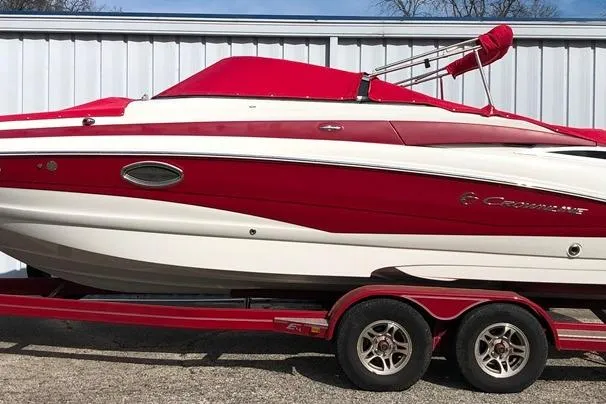 Slide: The Image of 2012 Crownline Eclipse E4 boat in red and white on a trailer. - 27