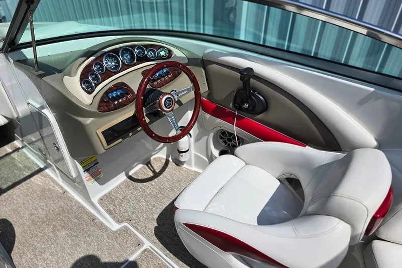 Slide: The Image of 2012 Crownline Eclipse E4 boat interior with sleek dashboard and comfortable seating. - 3