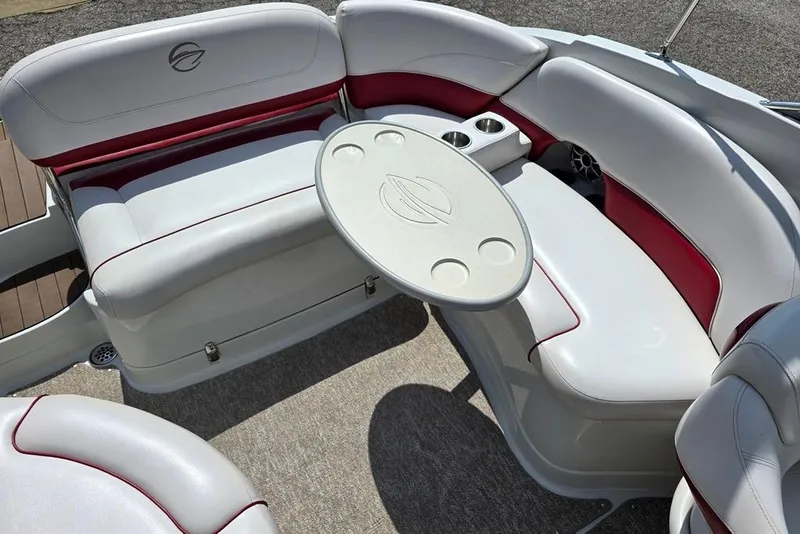 Slide: The Image of Luxurious seating area on a 2012 Crownline Eclipse E4 boat with table and cup holders. - 9