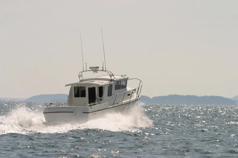 Slide: The Image of 2026 SeaSport Offshore 3000 cruising on open water, creating waves under a clear sky. - 10