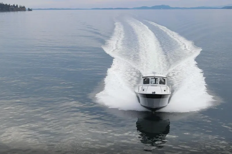 Slide: The Image of 2026 SeaSport Offshore 3000 cruising on calm waters, leaving a wake trail. - 12