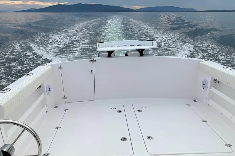 Slide: The Image of 2026 SeaSport Offshore 3000 boat cruising on calm waters with scenic mountain backdrop. - 13