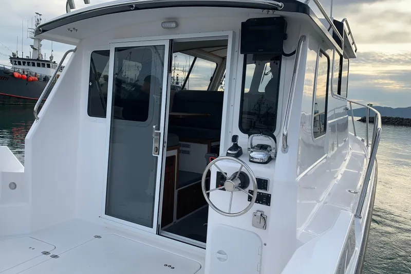 Slide: The Image of 2026 SeaSport Offshore 3000 boat with sleek design, docked at a marina. - 14