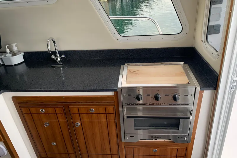 Slide: The Image of Modern kitchen in 2026 SeaSport Offshore 3000 boat with sleek countertops and stainless steel appliances. - 16