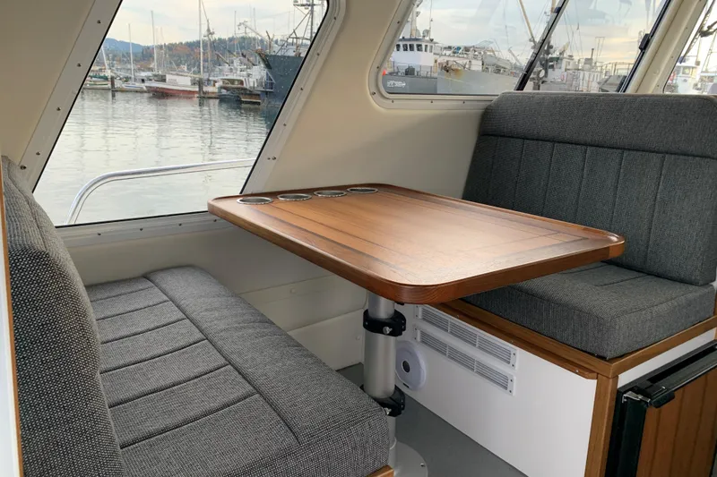 Slide: The Image of Interior of 2026 SeaSport Offshore 3000 boat with cozy seating and wooden table. - 17