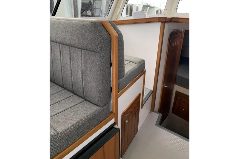 Slide: The Image of Interior of 2026 SeaSport Offshore 3000 boat with gray seating and wooden accents. - 22