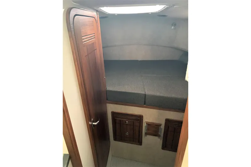 Slide: The Image of Cabin interior of 2026 SeaSport Offshore 3000 with wooden door and cozy bed. - 23