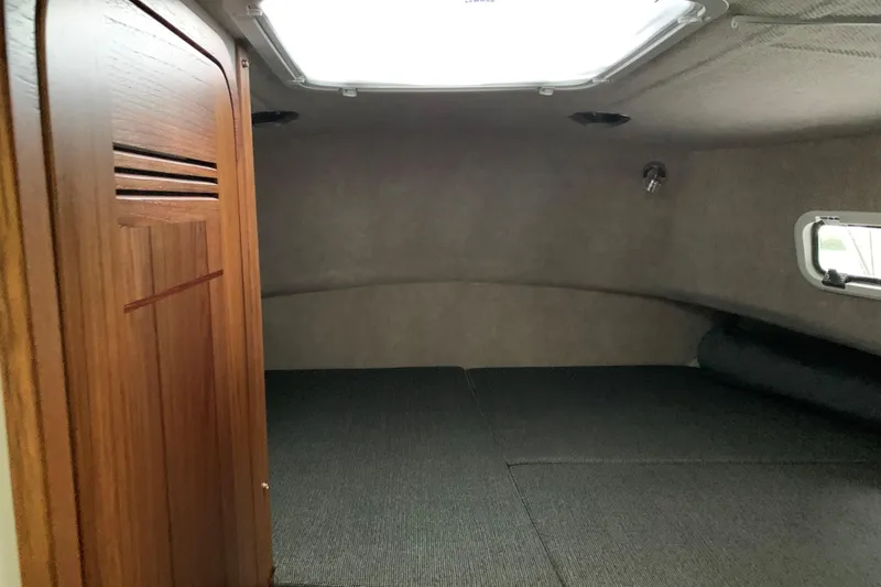 Slide: The Image of Interior cabin of 2026 SeaSport Offshore 3000 boat, featuring wood paneling and compact design. - 24