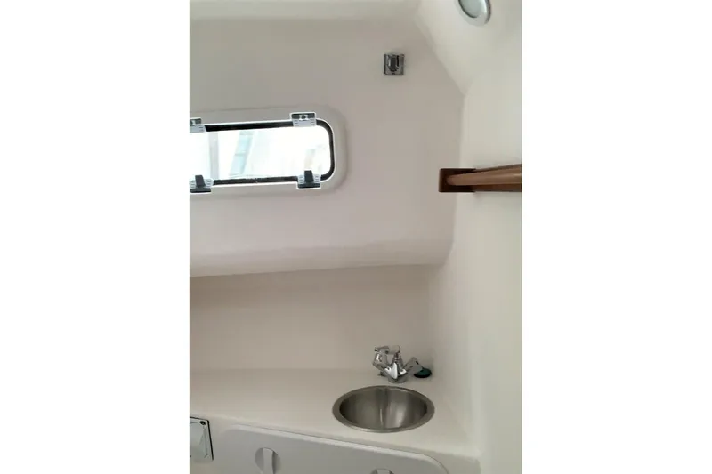 Slide: The Image of Interior of 2026 SeaSport Offshore 3000 boat featuring a compact sink and window. - 5