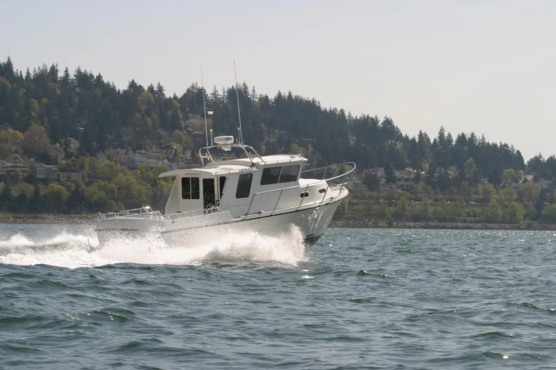 Slide: The Image of 2026 SeaSport Offshore 3000 cruising on a scenic lake with forested hills in the background. - 9