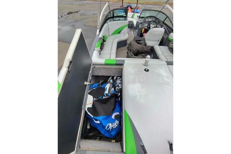 Slide: The Image of 2009 Moomba Mobius LSV interior with open storage compartment and seating. - 6