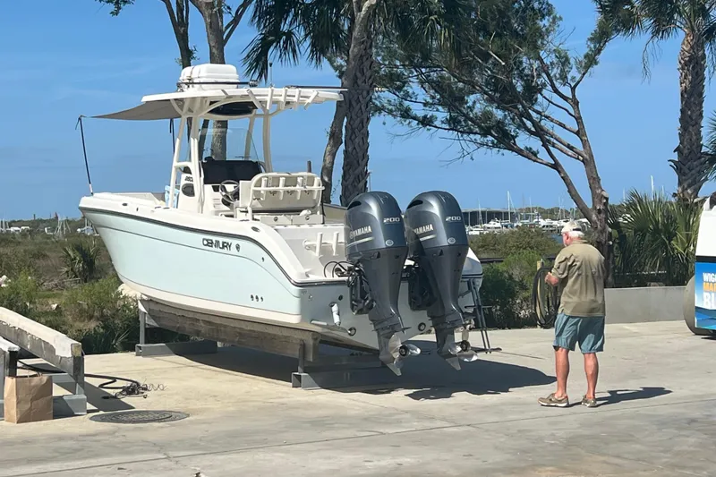 Slide: The Image of 2017 Century 2600 Center Console boat with dual Yamaha engines on a sunny day. - 4