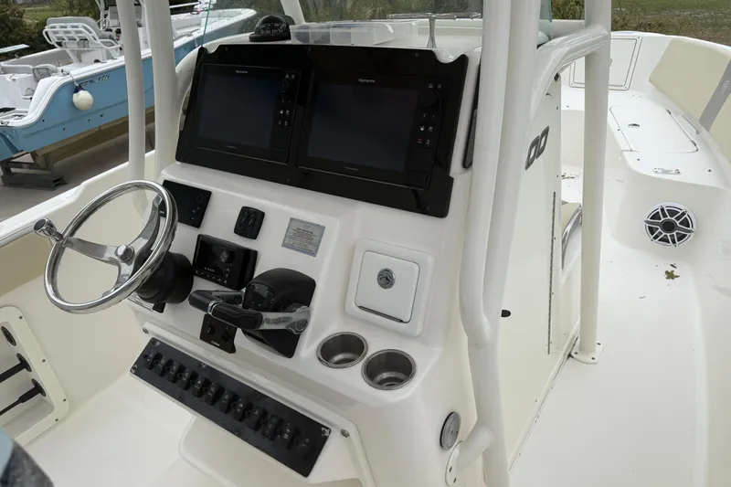 Slide: The Image of 2017 Century 2600 Center Console boat dashboard with steering wheel and navigation screens. - 7