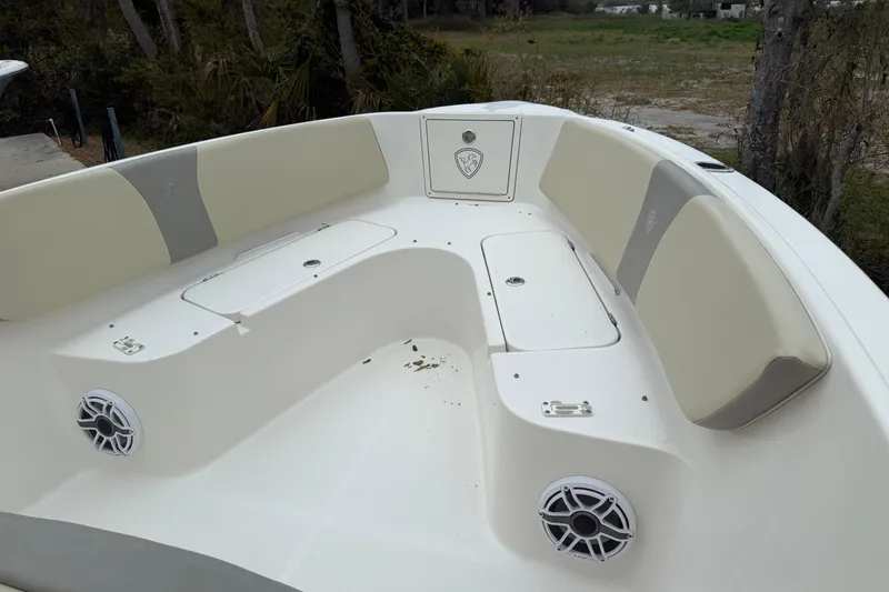 Slide: The Image of 2017 Century 2600 Center Console boat interior with cushioned seating and speakers. - 8