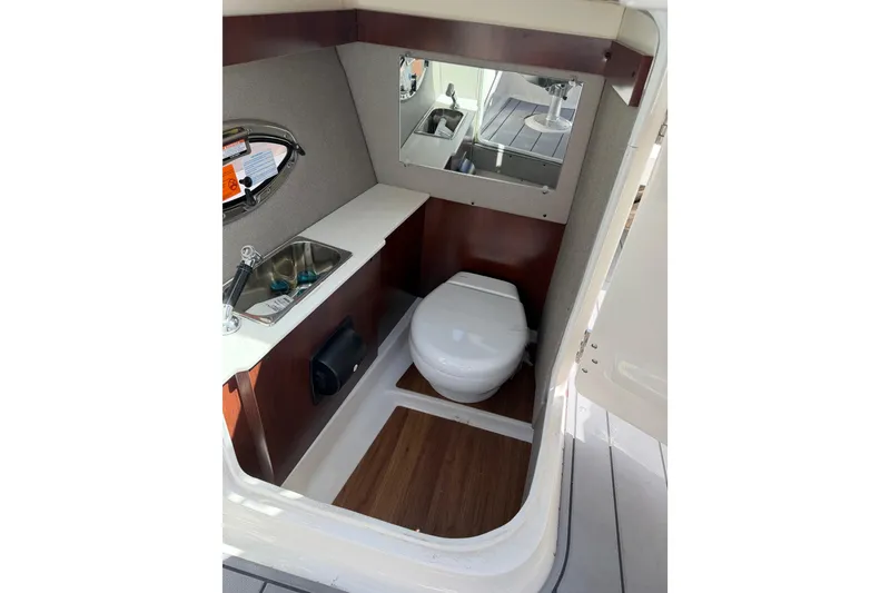 Slide: The Image of 2023 Chaparral 287 SSX boat interior bathroom with sink and toilet. - 10