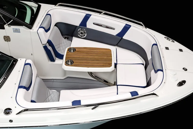 Slide: The Image of Manufacturer Provided Image: 2023 Chaparral 287 SSX boat interior with white and blue seating, wooden table. - 22