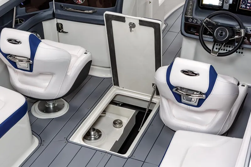 Slide: The Image of Manufacturer Provided Image: 2023 Chaparral 287 SSX boat interior with white and blue seating, open storage compartment. - 27