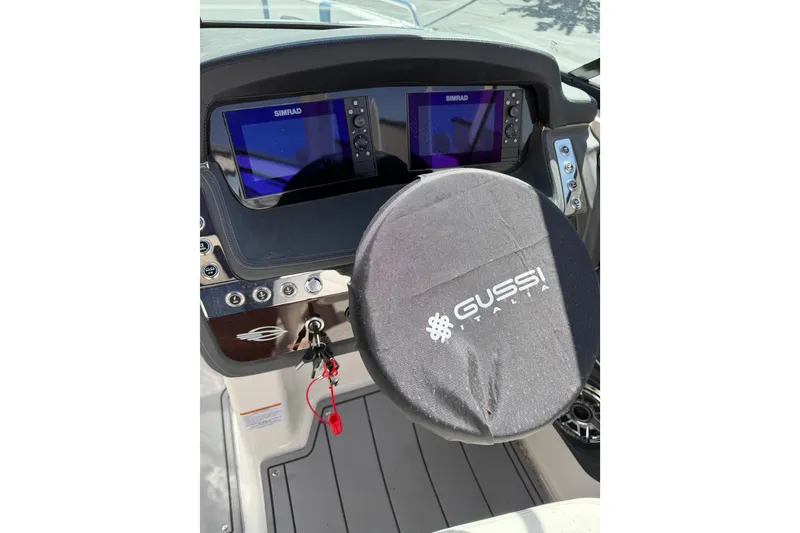 Slide: The Image of 2023 Chaparral 287 SSX boat dashboard with dual Simrad displays and Gussi Italia steering wheel. - 4