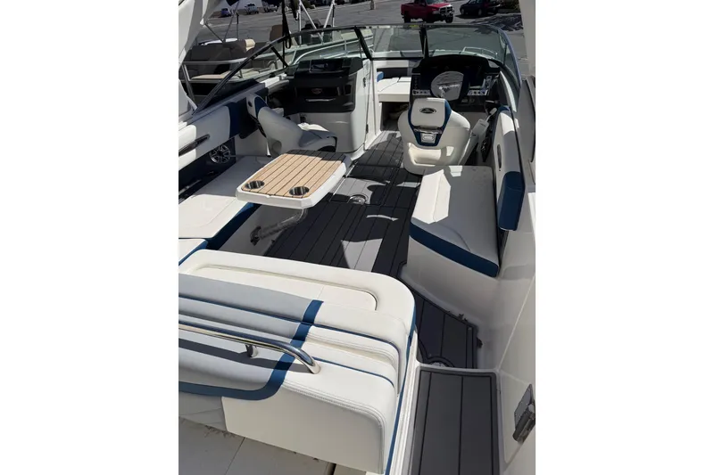 Slide: The Image of 2023 Chaparral 287 SSX boat interior with seating, table, and helm. - 5
