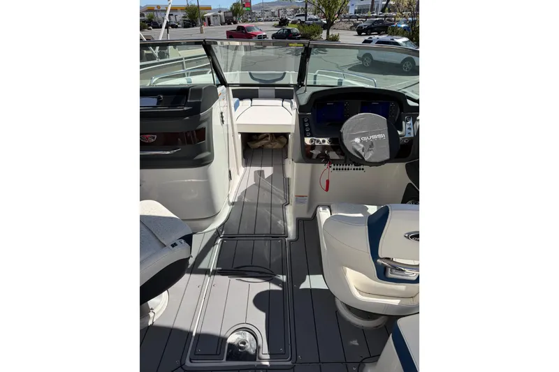 Slide: The Image of 2023 Chaparral 287 SSX boat interior with modern dashboard and seating. - 6