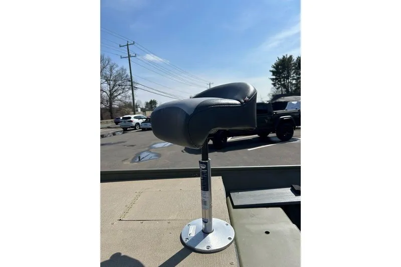 Slide: The Image of 2024 Lund UR1448MTD boat seat, mounted on a sunny day in a parking lot. - 10